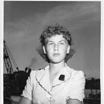 Woman wearing L.D. Smith pin with crane in background