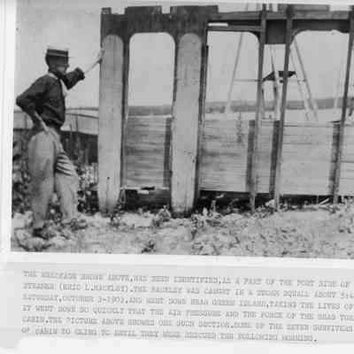 Man standing by wreckage of steamer Erie L. Hackley