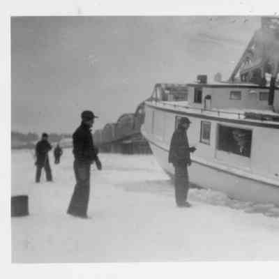Fishing tug Sparta in icy water at Sturgeon Bay Boat Works with men standing on ice