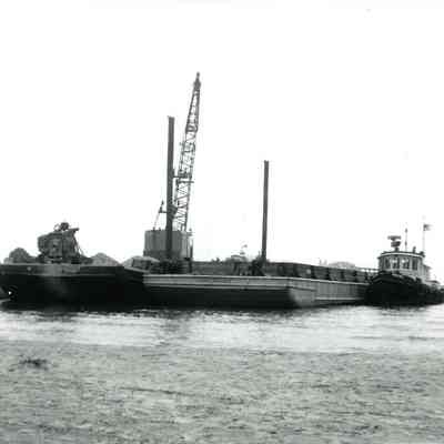 Tug Racine and crane barge filling pier with stone 1974