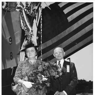 PC-825 ship sponsor holding roses next to man from ELKS club