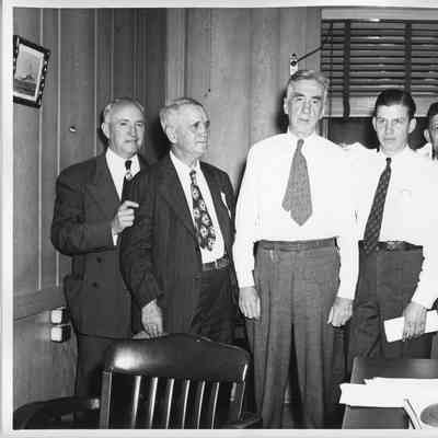 Three unidentified men, Thomas M. Woodward, Wolcott E. Spoffard