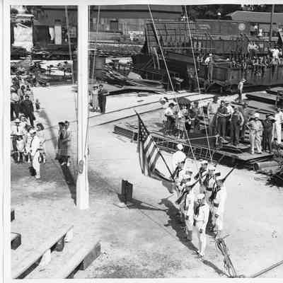 US Coast Guard color guard standing near flag pole