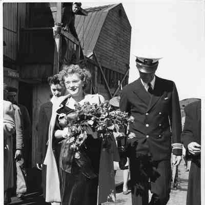 Woman holding roses at christening of PC-1178