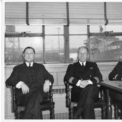 three unidentified men sitting in office