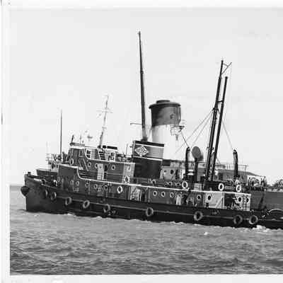 Tug John Roen IV in water alongside unidentified vessel