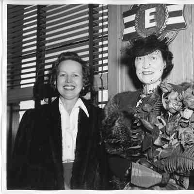 Mrs. W. H. Gallieane holding roses alongside Alva Smith