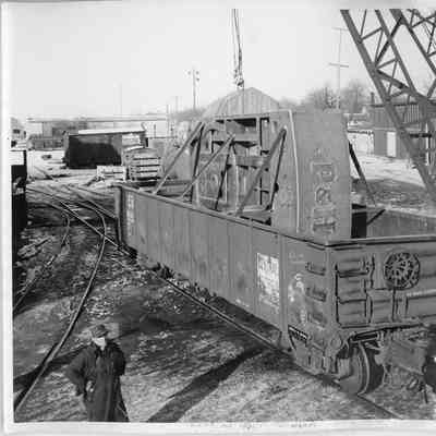 Lawrence Birdsall standing near loaded railroad car