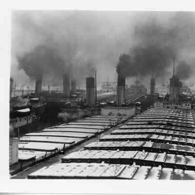 Several coarge vessels puffing dark smoke