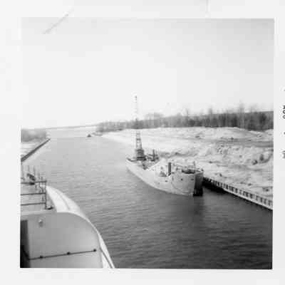 Ship with a load of stone and a crane underway in canal 1964