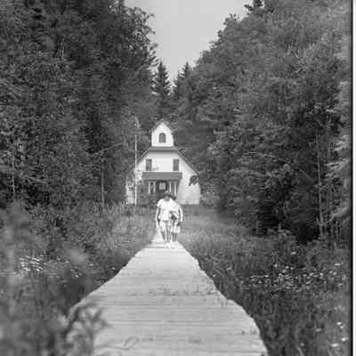 Baileys Harbor Range Light with two people walking on boardwalk