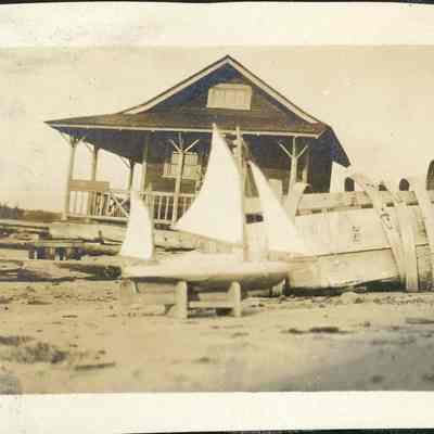 Model sailboat in front of house