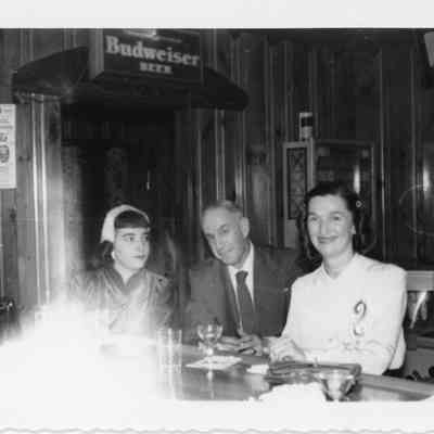 People sitting at bar during naval office party