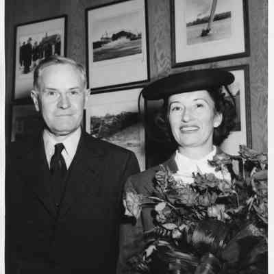 Mr. and Mrs. Sydney T. Smith holding roses