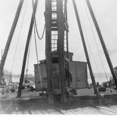 People on deck of Satifaction docked next to barge