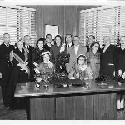 Group standing behind desk at christening of LST-1170, May 22, 1954