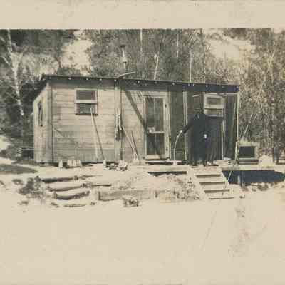 Man stands next to shack in Highland Park