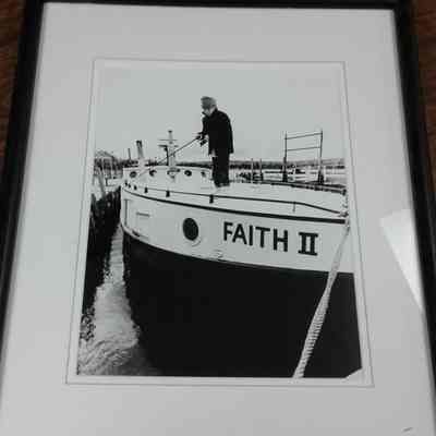 Framed photograph of Jeremy Brisson fishing off Faith II