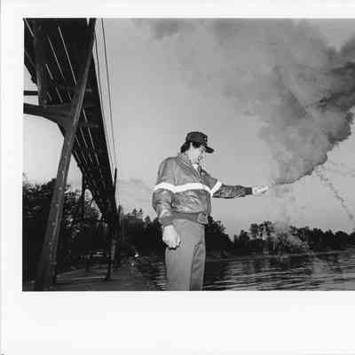 Man holding ignited signal flare