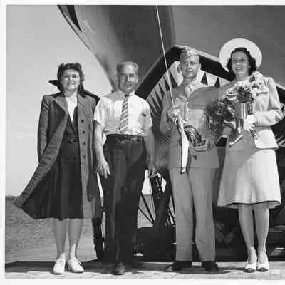 Ship sponsors bosing with christening bottle at christening of P-571 at Peterson Boat Works July 15, 1944