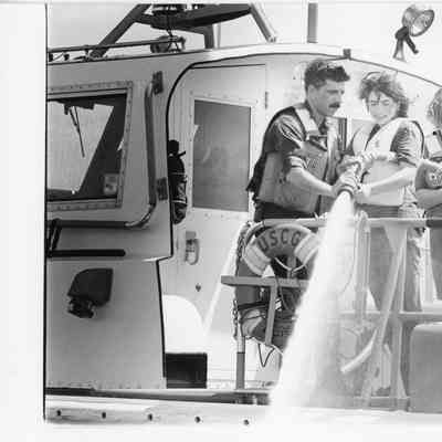 USCGC deck with 4 people using high pressure hose 1997