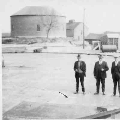 Three men standing on crib foundation