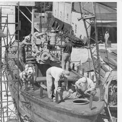 men working on boat being constructed
