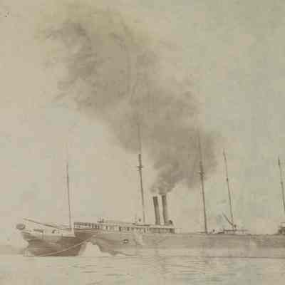 Steamer alongside sailing vessel