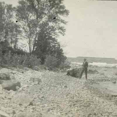Man on rocky shoreline