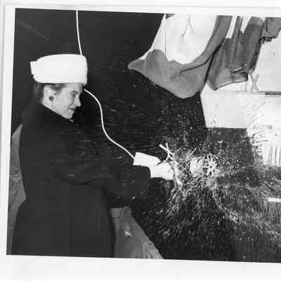 Woman christening boat