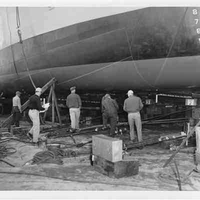 9 men getting LST-1170 being prepared to launch May 22, 1954