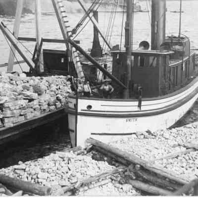 Tugboat Smith next to stone barge