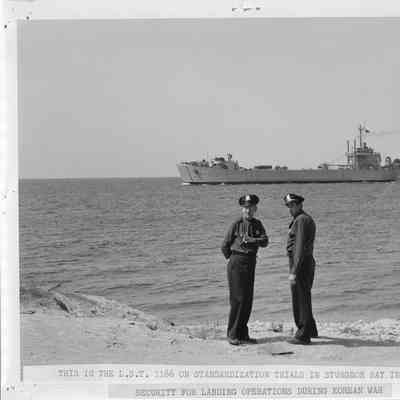 Two police officers on beach, security of LST-1166 sea trials 1953