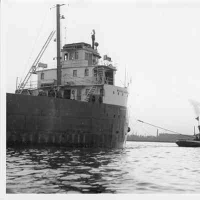 William H. Wold being towed by tugboat