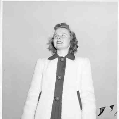 Patsy Smith wearing white coat with floral decorated gloves