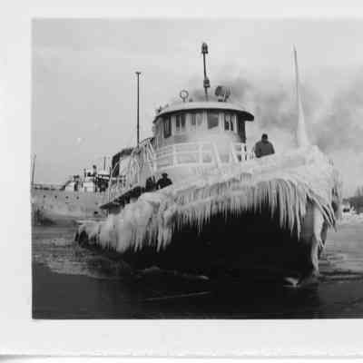 Roen Steamship Co. tug covered in ice underway