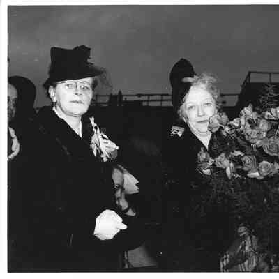 Mrs. Edward Frick holding roses with unidentified woman