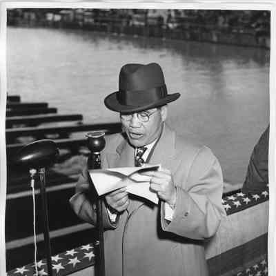 Unidentified man making speech by microphone