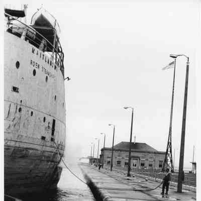 Maitland dockside with man on land holding line mid-1970s