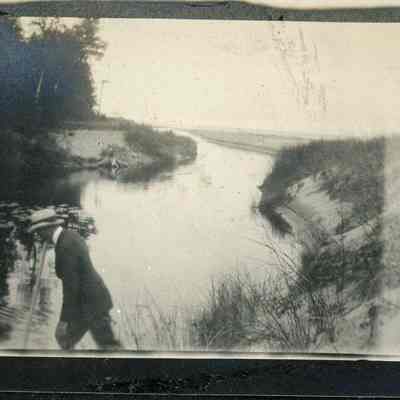 Man walking at Shivering Sands Creek 1923