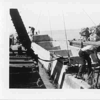 Men working on stone barge
