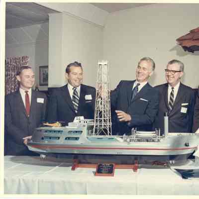 Group of people posing behind Alcoa Seaprobe model
