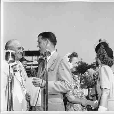 L. D. Smith, Alva Smith, and Mrs. Gus Johnson near mircrophone