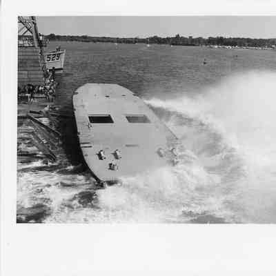 95' Tug hull just hitting the water, throwing spray