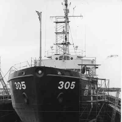 Coast Guard vessel 305 in drydock with man on deck