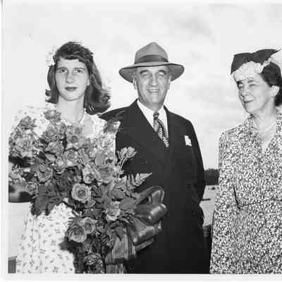 Miss Joan Burgess standing with her parents at PC-1175 christening