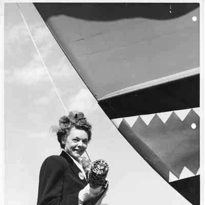 Mrs. W. DeFaut holding christening bottle at christening of F-568 April 12, 1944
