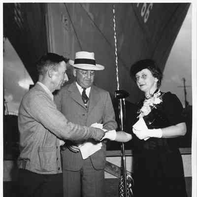 Mrs. John Butterweck, L.D. Smith, and third man in front of USS Reading pre-christening