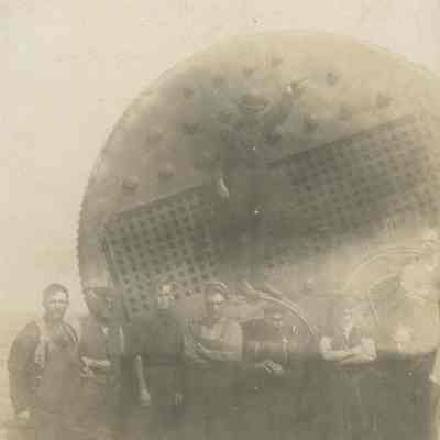 Workers posing with ship's boiler