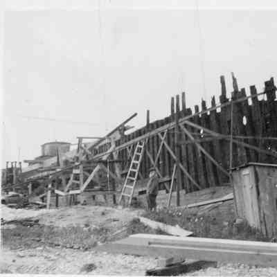 Man standing by vessel under construction